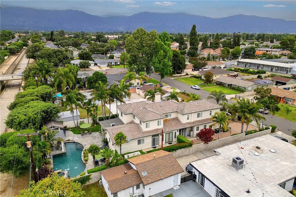 Aerial of 5219 McClintock with tile roof, paver drive, and the San Gabriel mountains rising behind